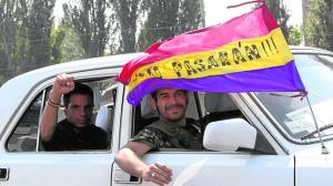 Angel and Rafa, who say they are from Spain, and volunteered to join pro-Russian separatists, ride a car in Donetsk